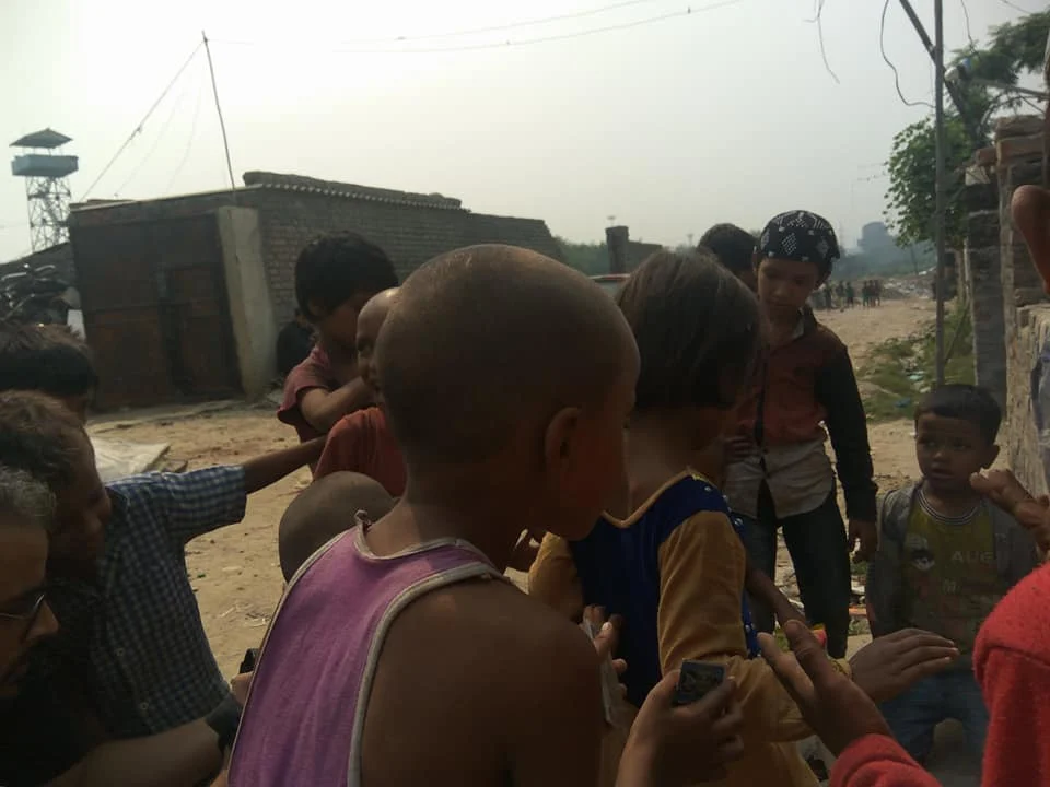 Group of kids interacting outdoors in a village setting.