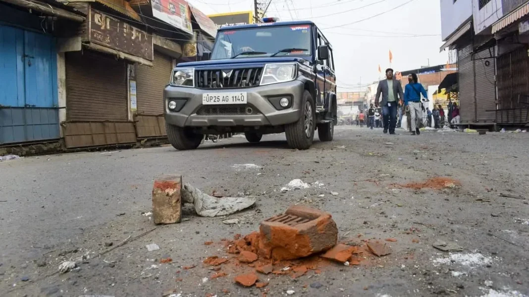 SUV driving through debris-strewn street with pedestrians.