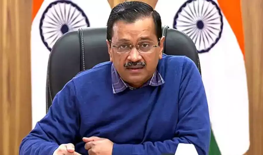 Man in office with Indian flag background.