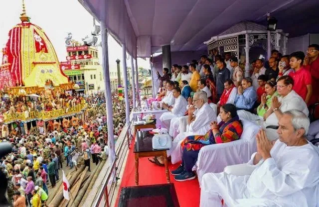 People observing a traditional festival procession from a balcony.