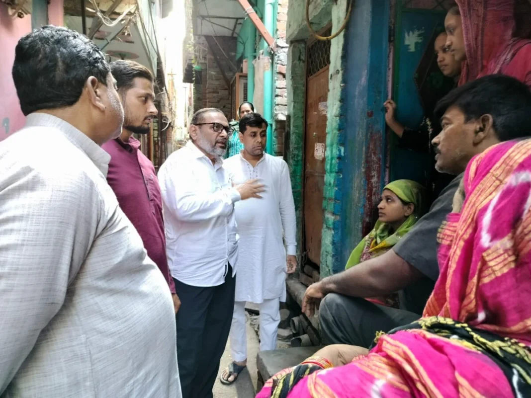 Group of people conversing in a narrow alleyway.