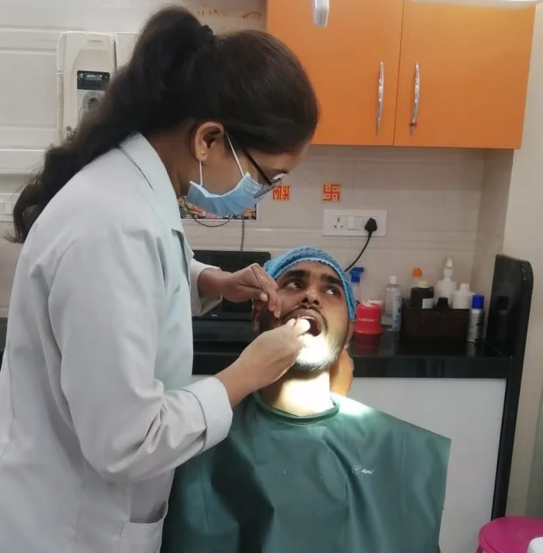 Dentist examining patient's teeth in clinic.