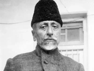 Elderly man with traditional cap in black and white photo.