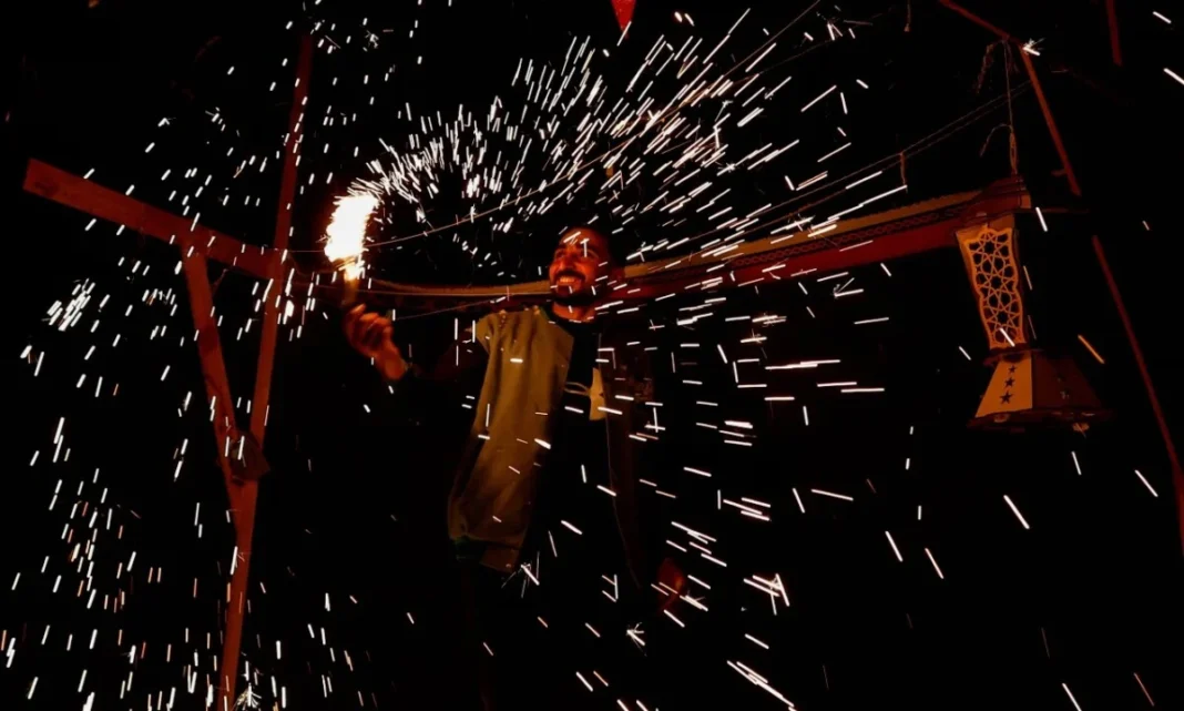 Man with sparklers creating light trails at night.