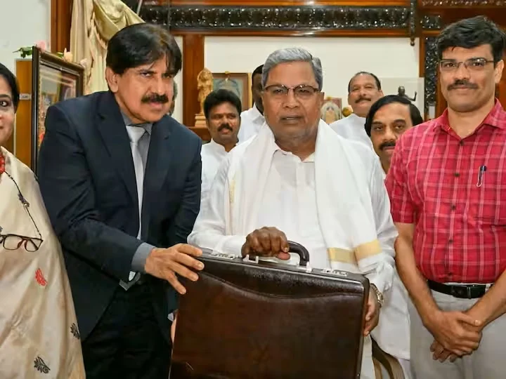 Officials presenting a briefcase indoors.