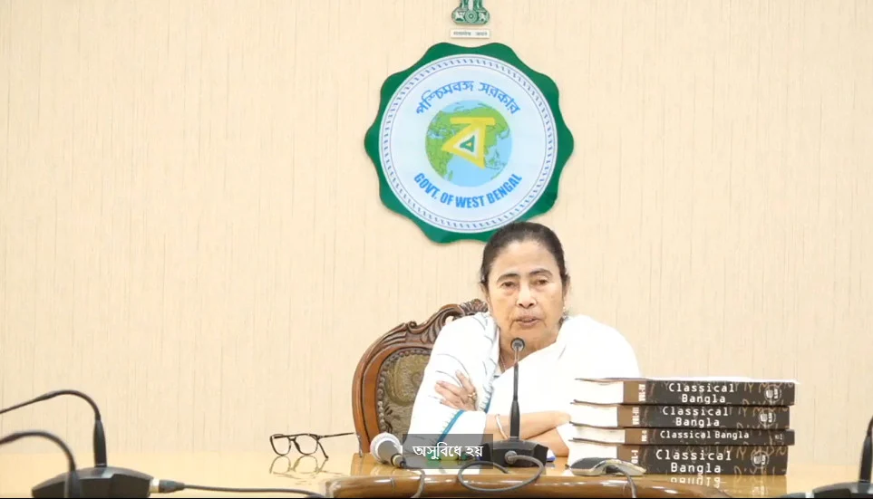 Woman at desk with microphone and books.